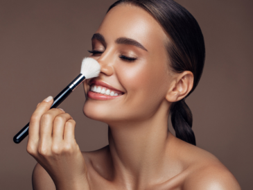 Beautiful Mediterranean woman putting on make-up